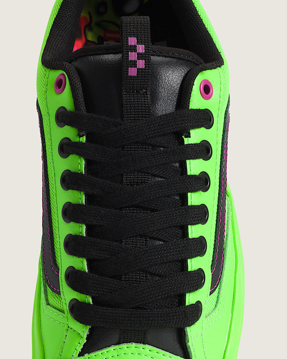 Green sneaker with black laces on a light gray background