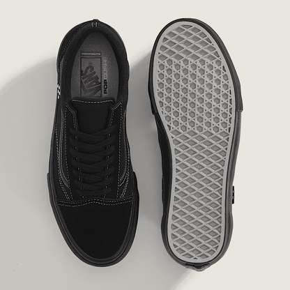 Black sneaker with a focus on sole texture on a light gray background