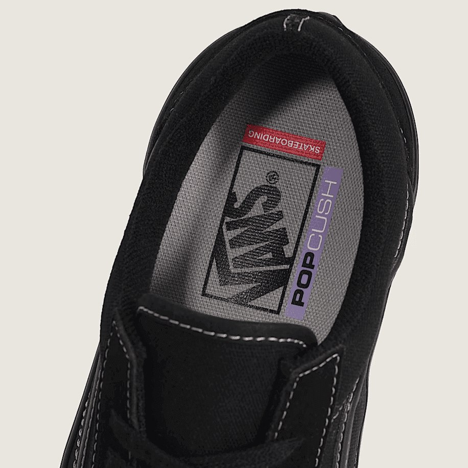 Black sneaker with visible brand logo on a light gray background