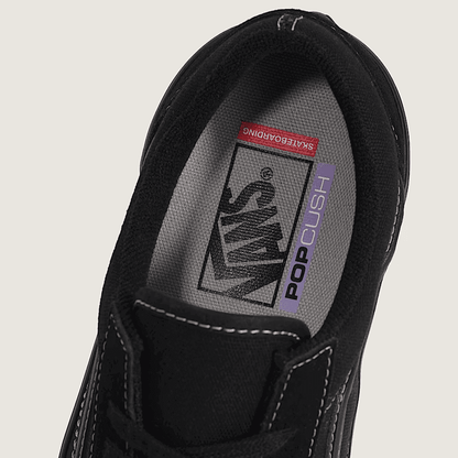 Black sneaker with visible brand logo on a light gray background