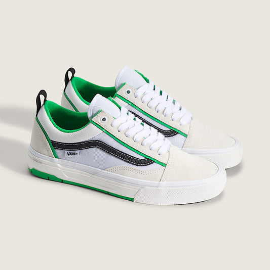 White sneakers with green accents on a white background