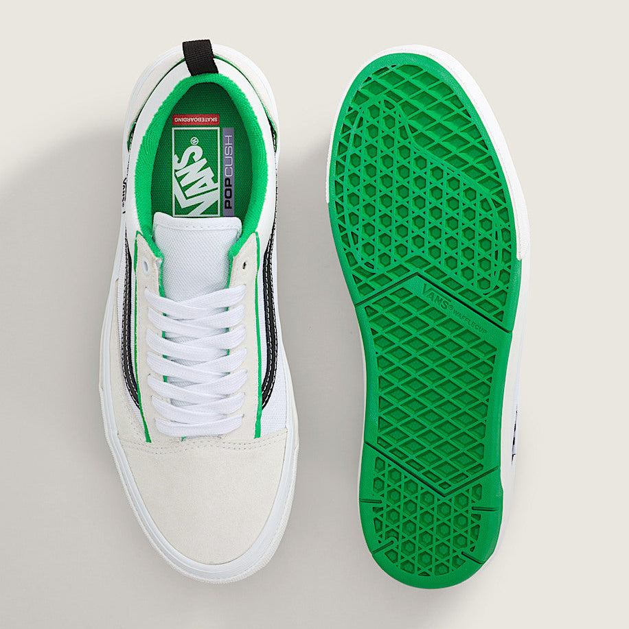 White sneaker with green sole on a white background