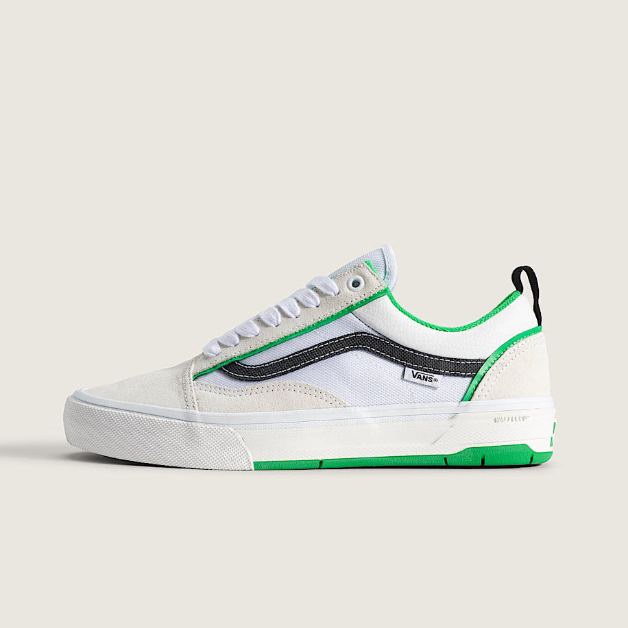 White sneaker with green accents on a white background