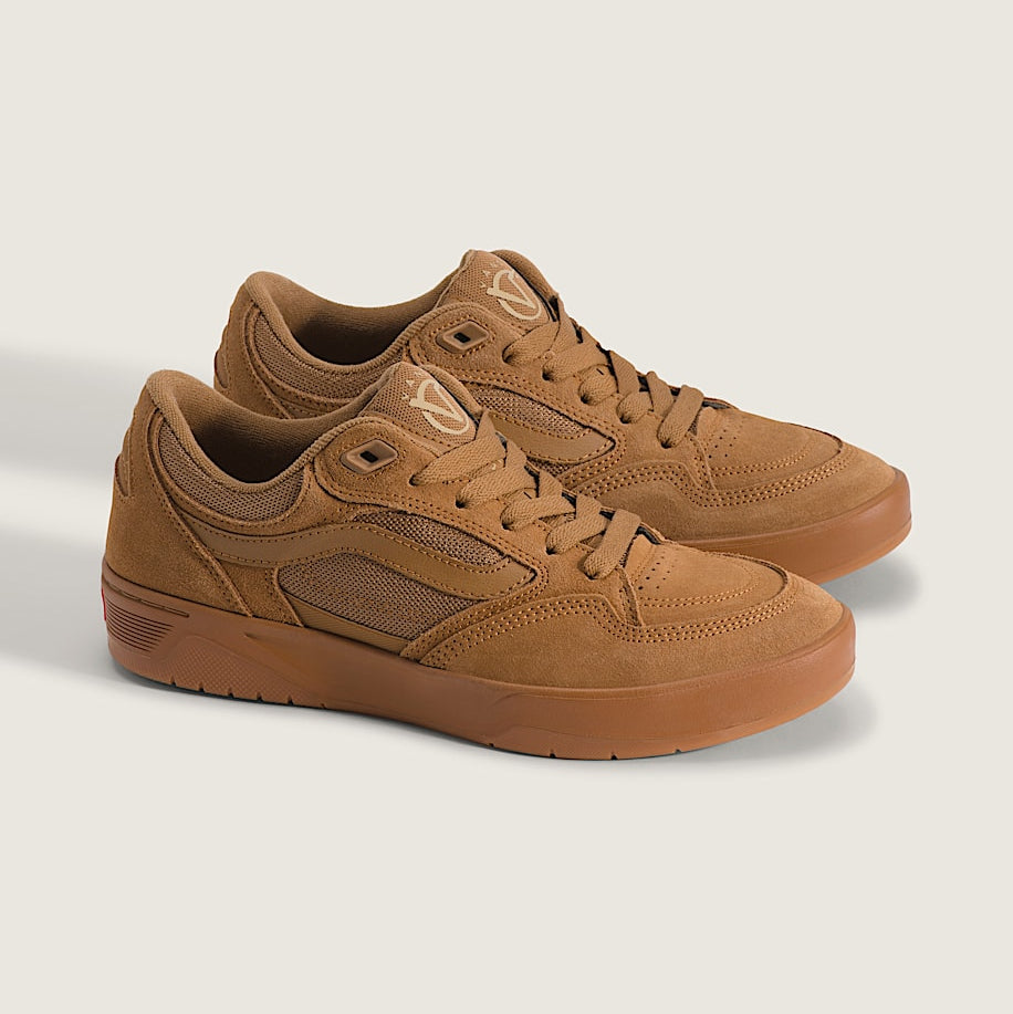 Pair of brown sneakers on a light gray background
