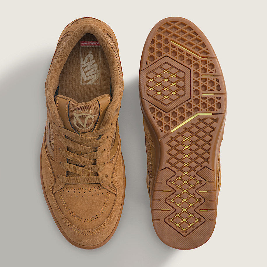 Brown sneaker with textured sole on a light gray background