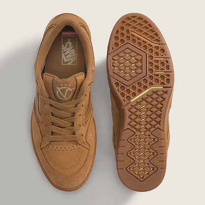 Brown sneaker with textured sole on a light gray background