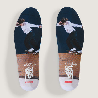 A pair of custom-printed skateboarding insoles shown flat against a light gray background. The insoles feature a graphic of a skateboarder in a white shirt and black pants on a dark navy blue upper section, transitioning into a brown wood-grain section with white and red Supreme branding.