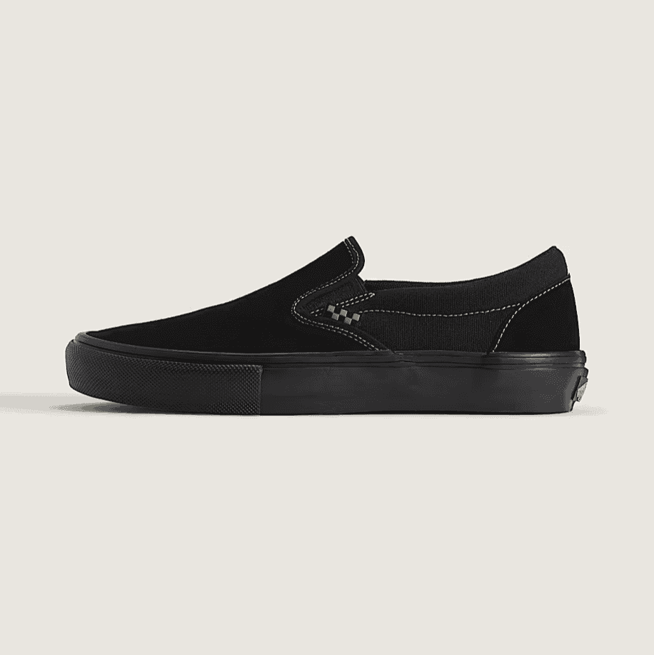 Black slip-on sneaker on a beige background