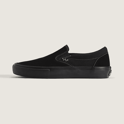 Black slip-on sneaker on a beige background