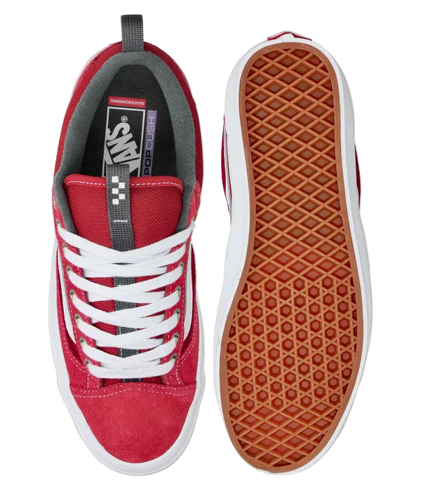 Red sneaker with white laces and brown sole on a white background