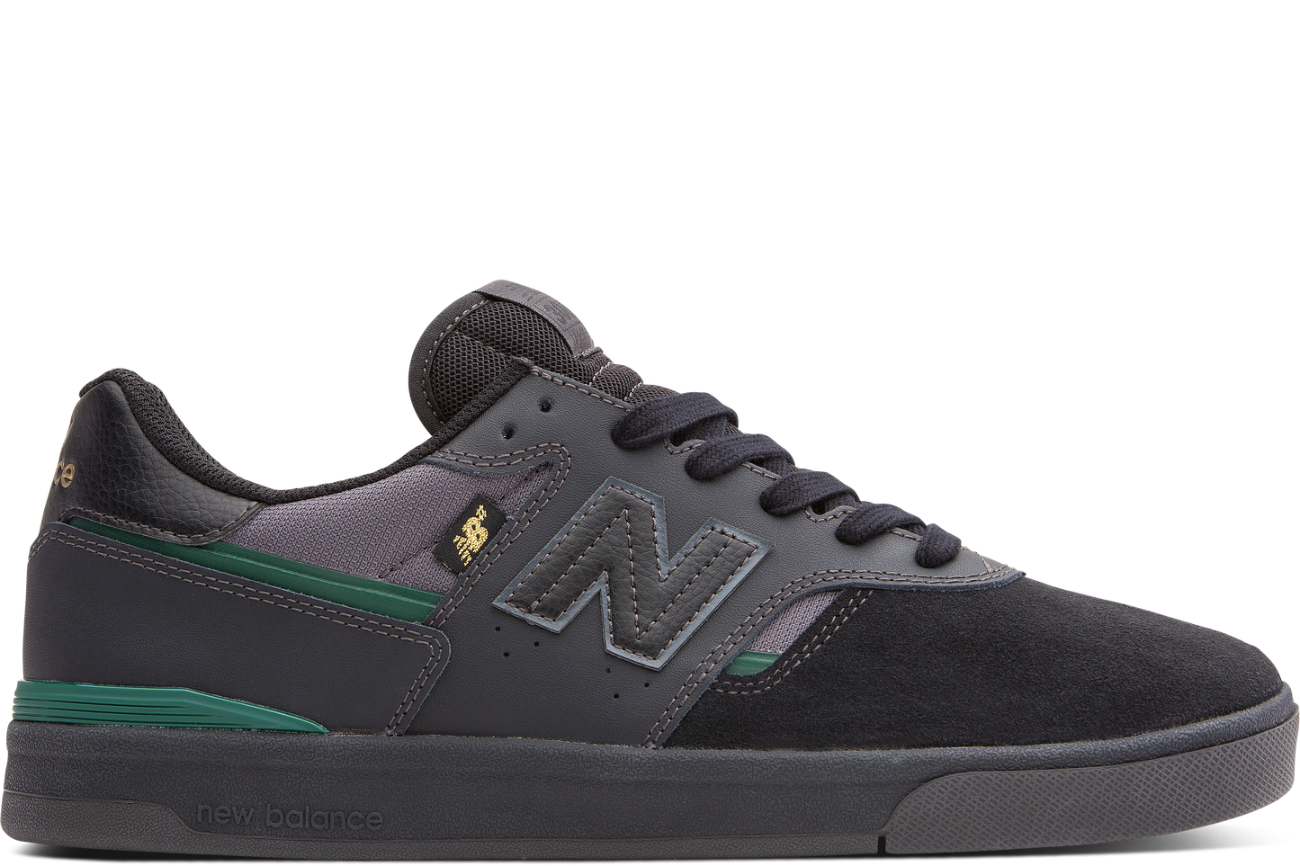 Black and gray sneaker with green accents on a white background