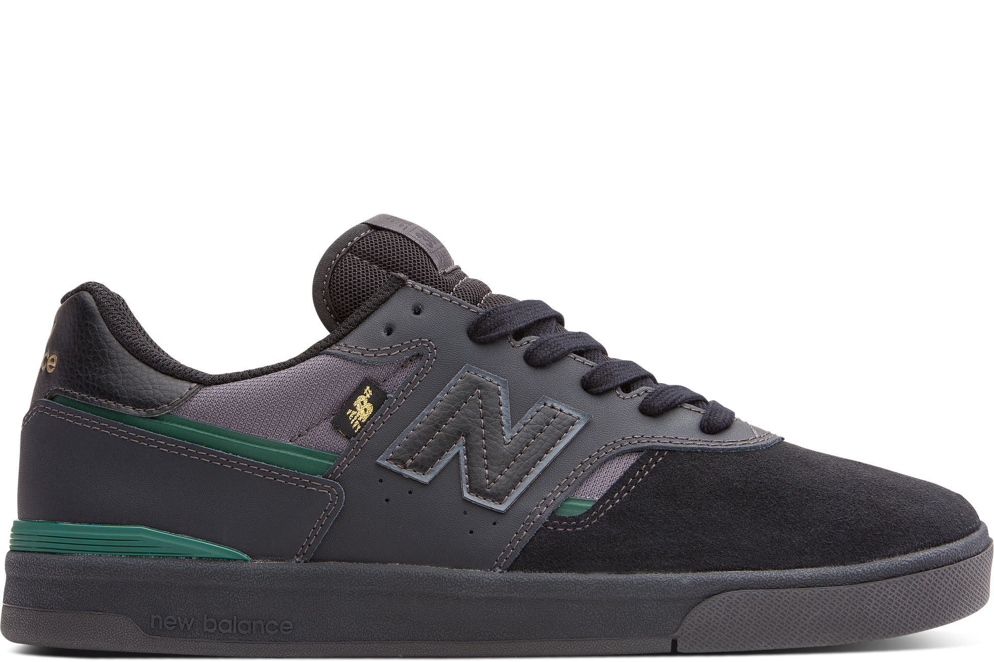 Black and gray sneaker with green accents on a white background