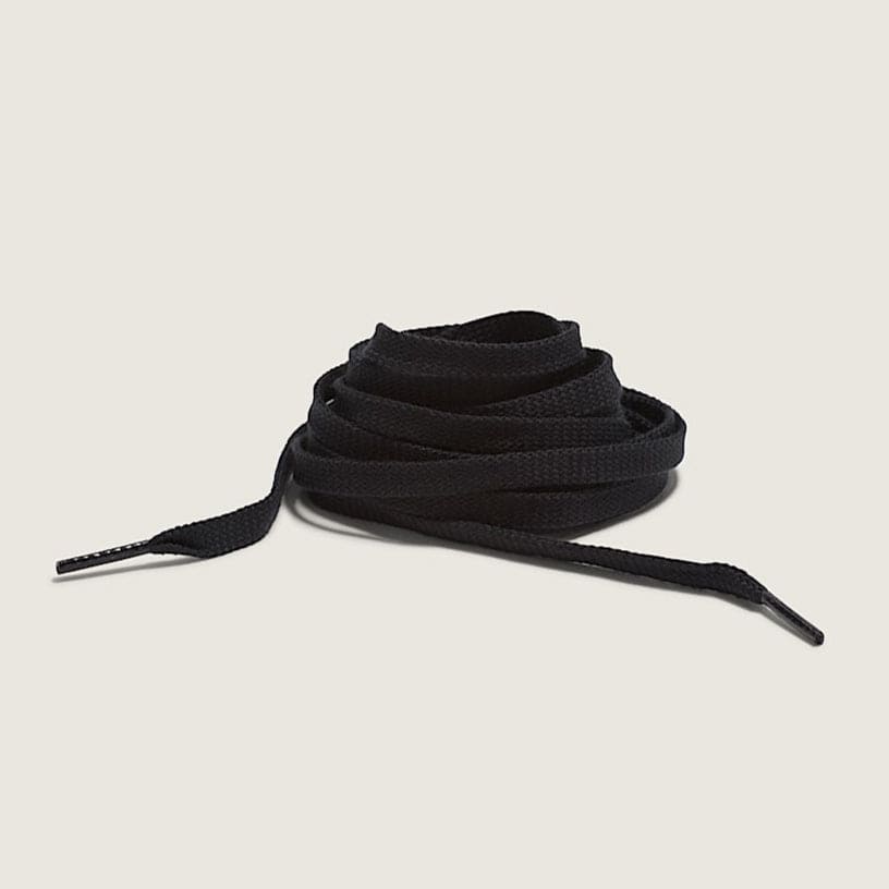 Black shoelaces on a beige background