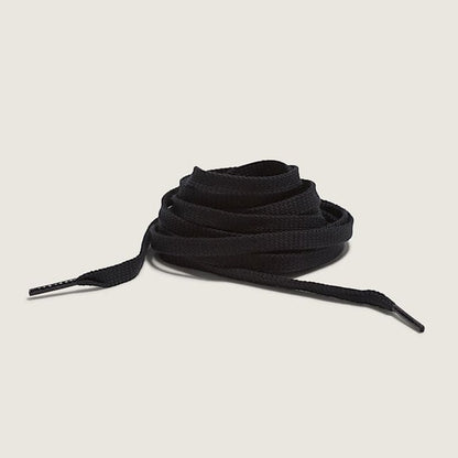 Black shoelaces on a beige background