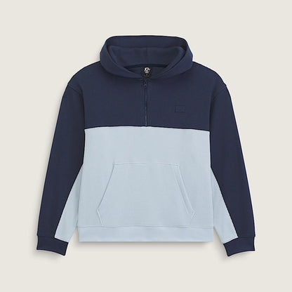 A color-blocked pullover hoodie with a navy blue upper section and sleeves, a light blue lower body, and a light blue front pocket, shown on a neutral beige background.