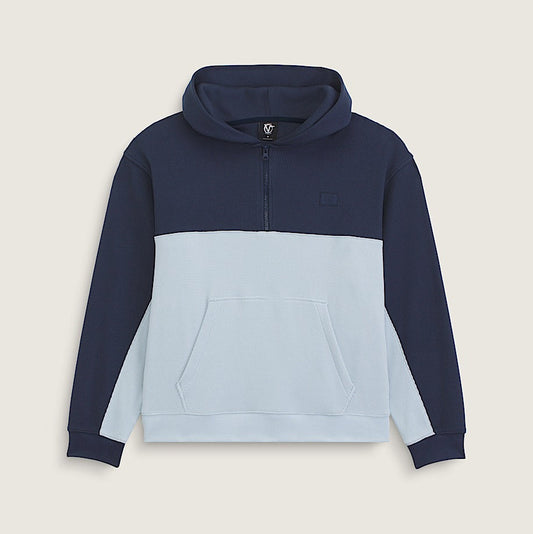 A color-blocked pullover hoodie with a navy blue upper section and sleeves, a light blue lower body, and a light blue front pocket, shown on a neutral beige background.