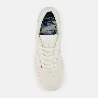 White sneaker with colorful sole on a white background