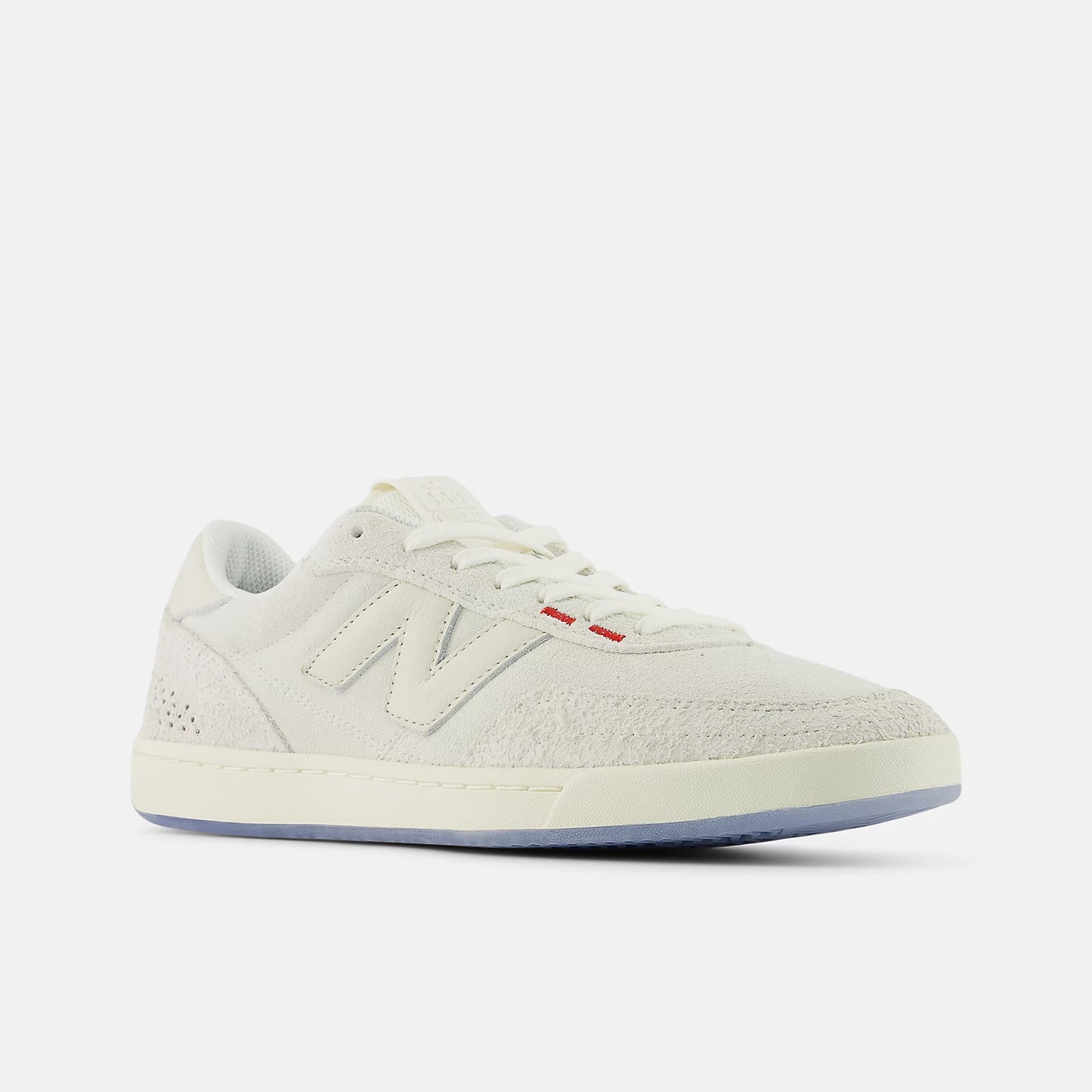 White sneaker with red label on a light gray background
