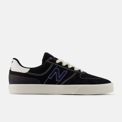 Black sneaker with white sole and blue 'N' logo on a white background