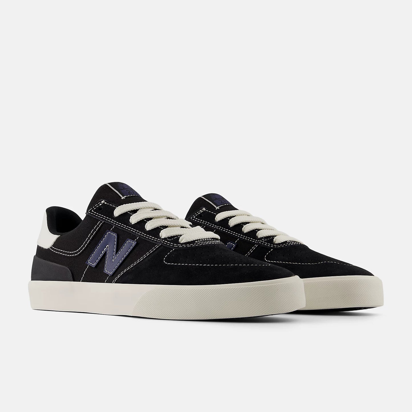 Black sneakers with white soles on a light gray background