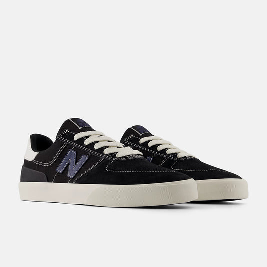 Black sneakers with white soles on a light gray background