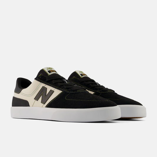 A pair of New Balance 590 skate shoes in black suede and off-white canvas, featuring a dark gray 'N' logo on the side, black laces, and a thick white rubber sole, set against a light gray background.