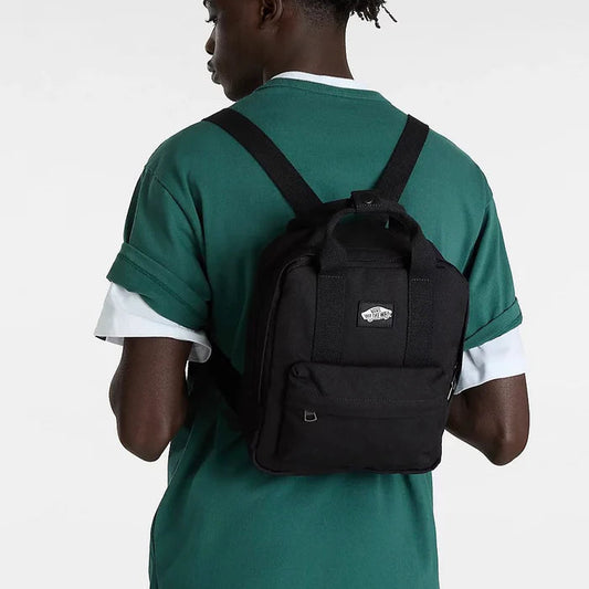Person wearing a black backpack with a visible brand logo on a white background